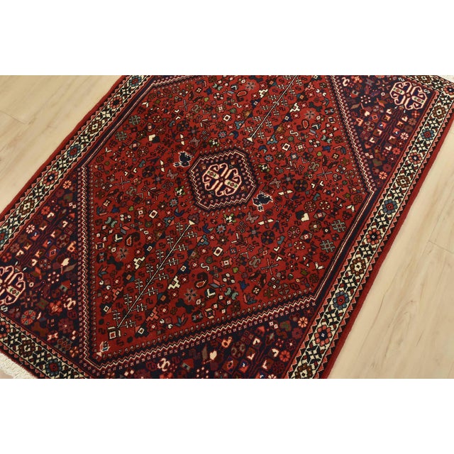 An authentic vintage tribal Abadeh rug hand-knotted with fine wool and natural dyes. This intricately woven rug features a...