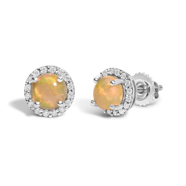 Immerse yourself in the allure of these exquisite 10K white gold stud earrings, each centered with a captivating 5mm...