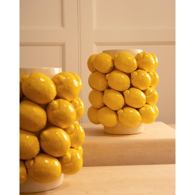 Large ceramic lemon vases - 20th century: a circular white ceramic base onto which a series of yellow lemons are glued.