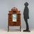 Art Nouveau walnut display case. The display case features a perforated and carved frieze and a small central shelf. The...