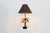An eye-catching Hollywood Regency table lamp from 1970s France, crafted in brass and designed in the form of an elegant...