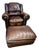 This a lovely chestnut brown worn library chair that is uniquely compact enough to use as a comfy lounge library club...