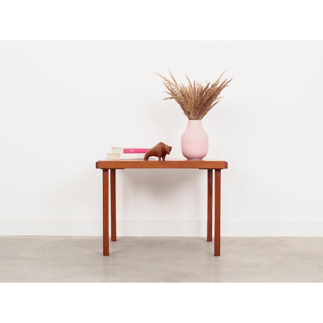 The coffee table was made in the 1970s, Danish production. The table top is covered with teak veneer. The legs are made of...