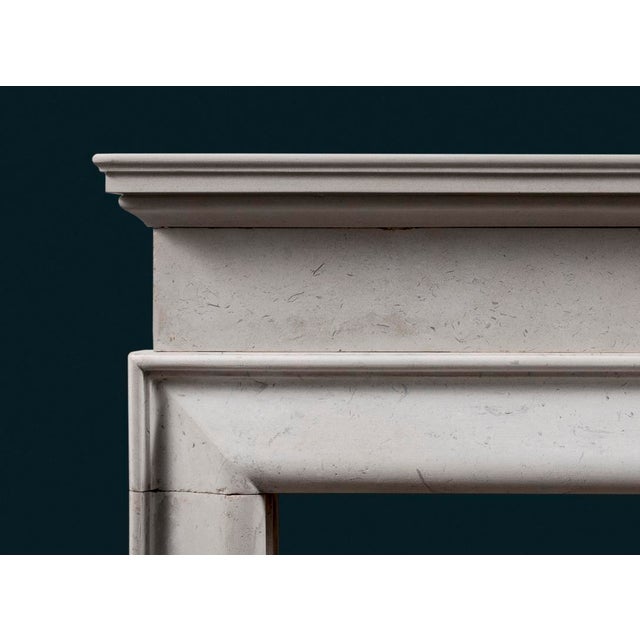 A Victorian architectural form Portland Stone bolection fireplace surround, with moulded shelf set above plain frieze, the...