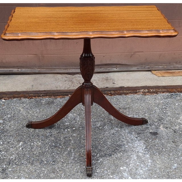 An antique English Mahogany Supper Table, likely dating to the Regency period around 1820s. It features a tripod base and...