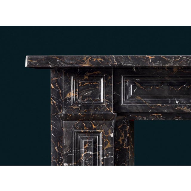A splendid antique nineteenth-century Regency period Portoro marble fireplace surround, the frieze, corner-blocks and...