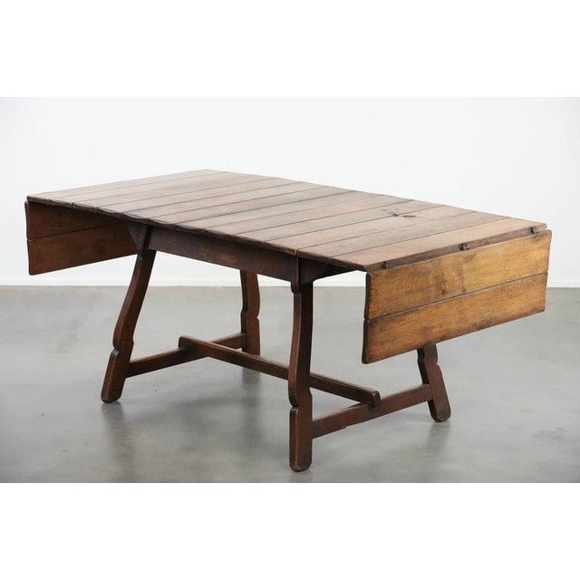 We are offering this unique and special antique Swiss folding dining table made of oak from the mid-19th century. This...