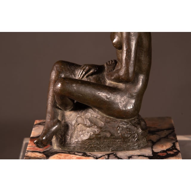 Wonderful Italian sculpture representing a seated maiden. The artwork rests on a square marble base Signed on the base...