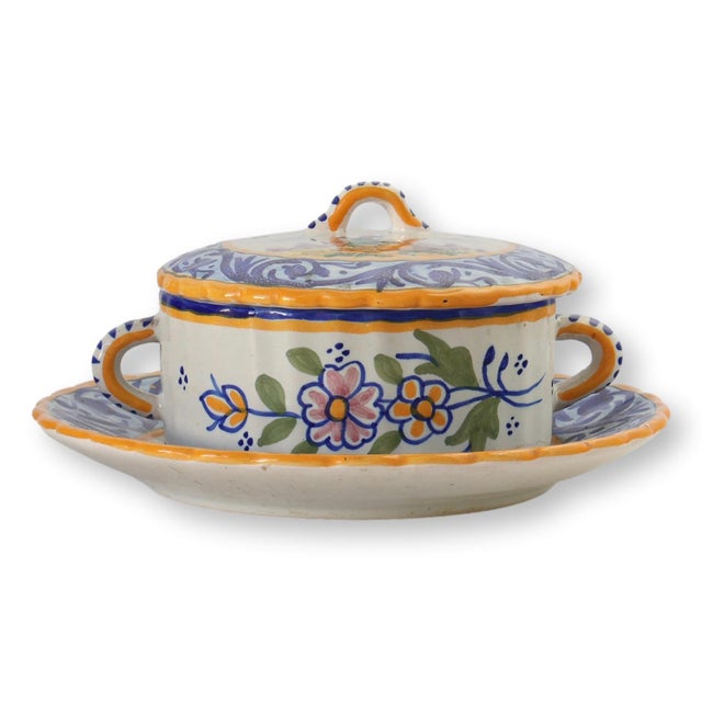 This charming Quimper faience butter dish from the early 20th century features vibrant hand-painted floral motifs in...
