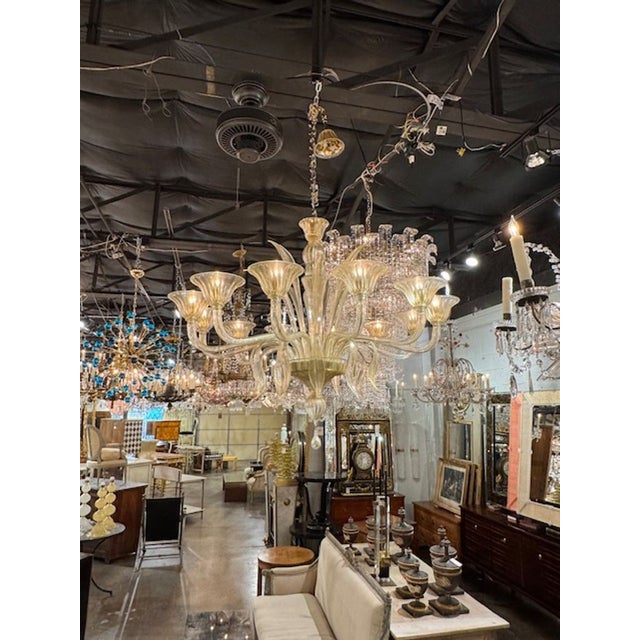 Modern Murano glass 12-light leaf chandelier in light gold. The chandelier has been professionally rewired, comes with...