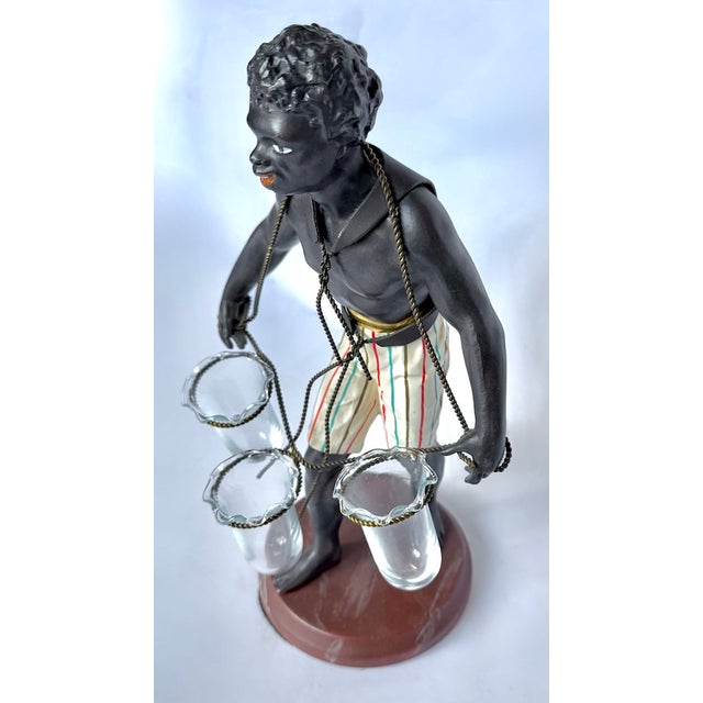 An excellent vintage figural triple bud vase or flower holder, designed in the characteristic style of Petite Choses. The...