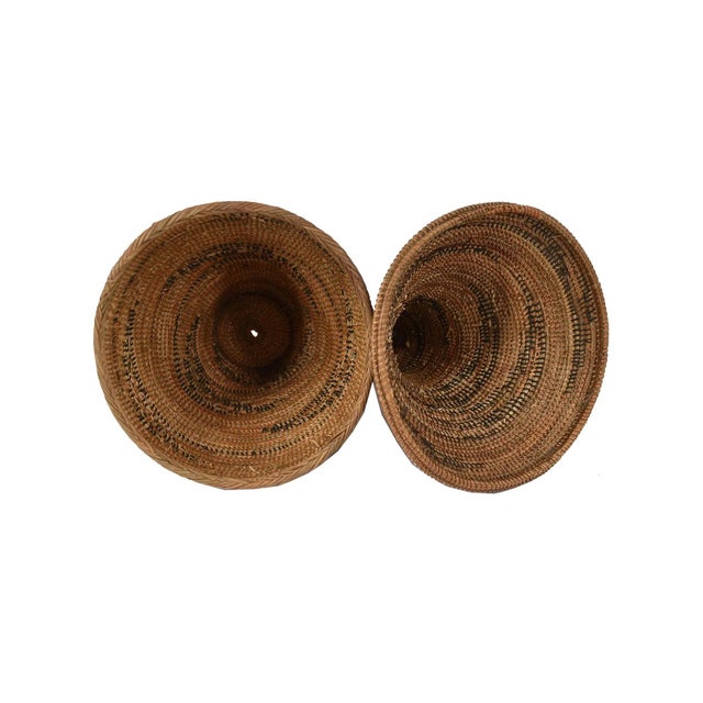 The Tutsi Tight Weave Basket with Lid from Rwanda epitomizes the artistry and tradition of the Tutsi community's weaving...