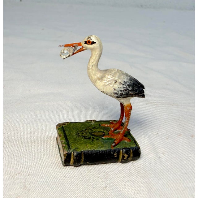 Up for sale is an antique 19th century Austrian Vienna bronze stork standing on a book carrying baby statue, a beautifully...