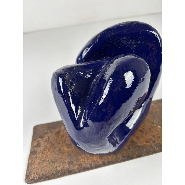 A ceramic sculptural artwork that serves as a unique and refined addition to any sophisticated table within a contemporary...