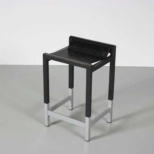 A rare model bar stool, designed by Ruud Jan Kokke in the Netherlands around 1970. Made of black lacquered wood with metal...