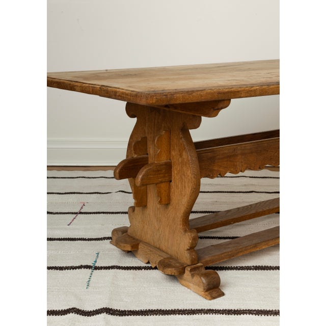 Danish oak trestle coffee or side table with carved lyre-form pedestals, scalloped apron, double stretcher. Mid-Century...