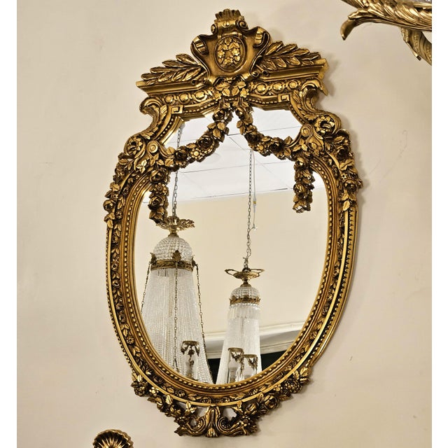 Bring regal elegance to your interior with this exquisite French Baroque-inspired oval wall mirror. Its beautifully...