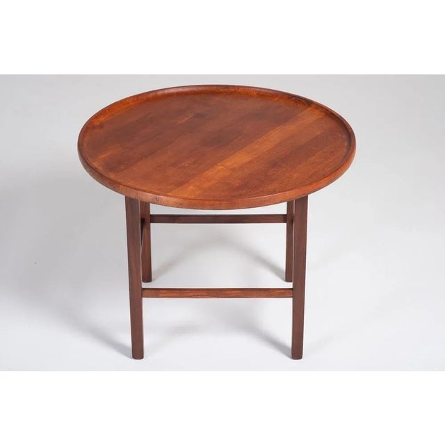 High quality round side table in solid teak with raised edge. Danish design, 1960s. This table would be easy to fit in...