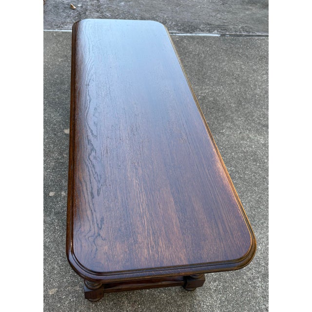 Nice dark oak rustic or French country coffee table with two drawers and turned legs.