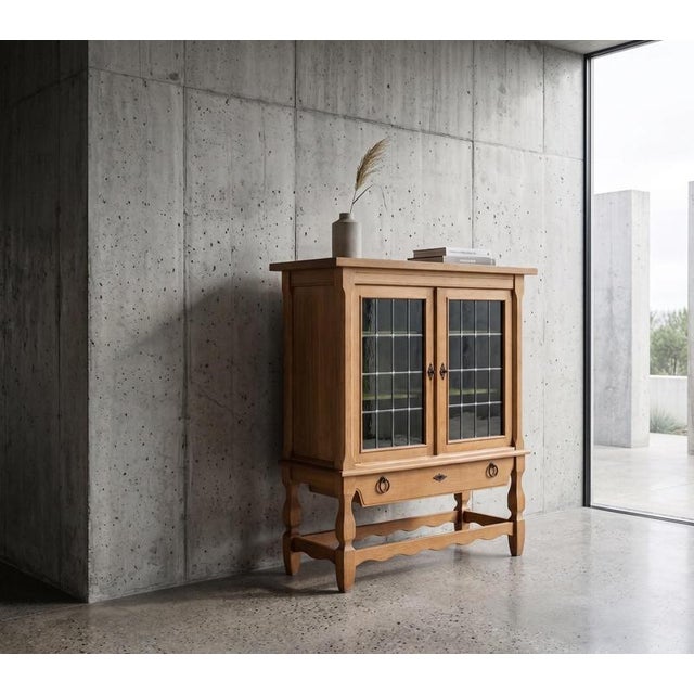 Oak cabinet attributed to Danish designer Henning Kjærnulf, crafted in Denmark during the 1960s. Executed in a distinctive...