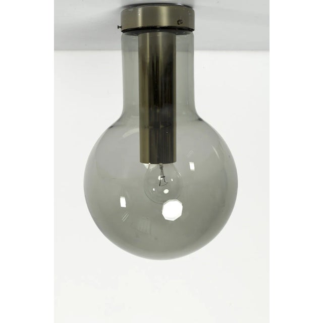 Wonderful vintage ‘maxi globe p-1260’ ceiling lamp by raak from the 1970s. Made of beautiful transparent smoke glass with...