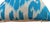 A sky blue silk ikat cover with a visible abraj running across the field — a natural tonal shift in the ground color that...