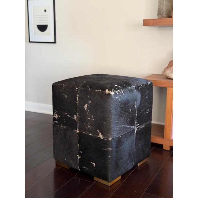 Made Goods Essex stool in the coveted Midnight hair-on-hide finish, featuring a rich black leather base with natural ivory...