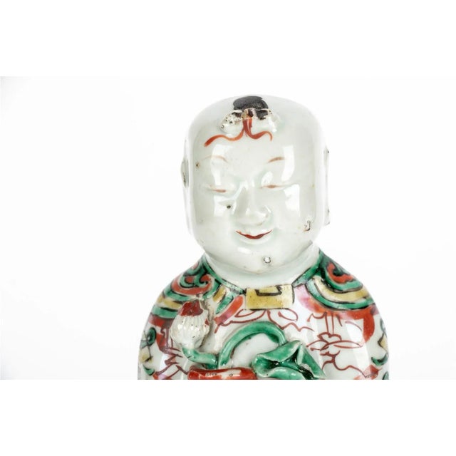 Antique 17th century Chinese Kangxi porcelain figure of a laughing Ho Ho Boy holding a vase in famille vert glaze....