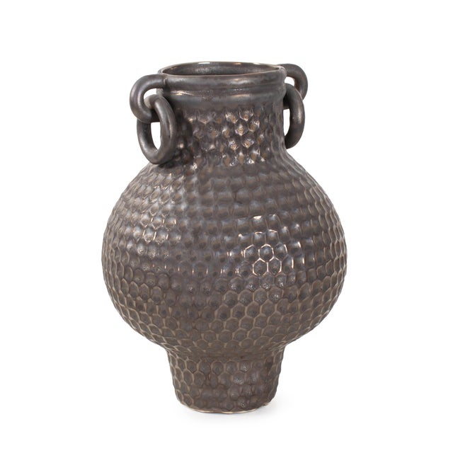 Crafted with a bold silhouette and richly hammered texture, this iron-finished vessel blends industrial edge with timeless...
