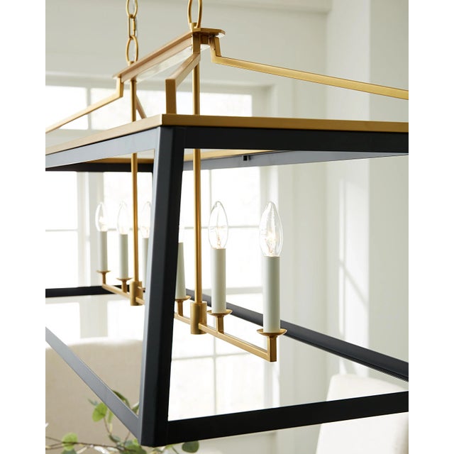 The Carlow six-light billiard island chandelier in midnight black is a traditional tapered square lantern that is wider at...