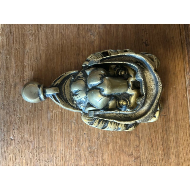 This vintage English brass lion head door knocker is a striking piece of classic design, hand-selected in England and...