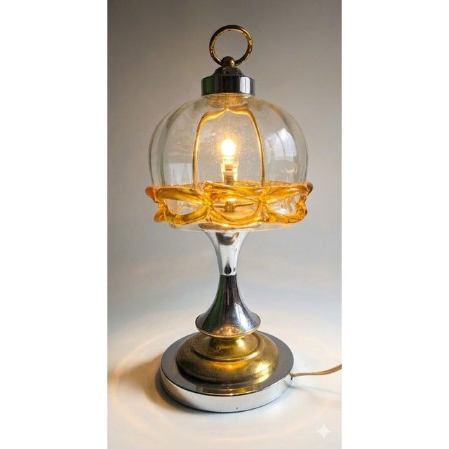 A fascinating Space Age lamp made of chrome-plated metal and hand-blown glass, originating from Germany and manufactured...