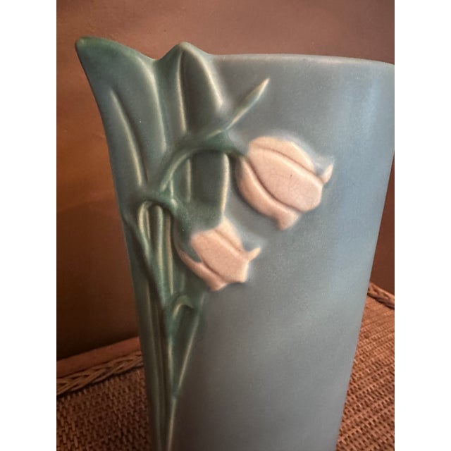 This Vintage Weller Art Pottery B-11 Lily of the Valley Blue 12" vase is a beautiful example of early 20th-century art...