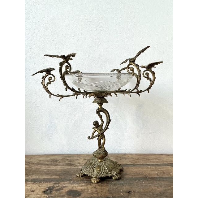 This exceptional Victorian-style epergne is a masterwork of neoclassical design, featuring an intricate brass frame that...