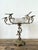 This exceptional Victorian-style epergne is a masterwork of neoclassical design, featuring an intricate brass frame that...