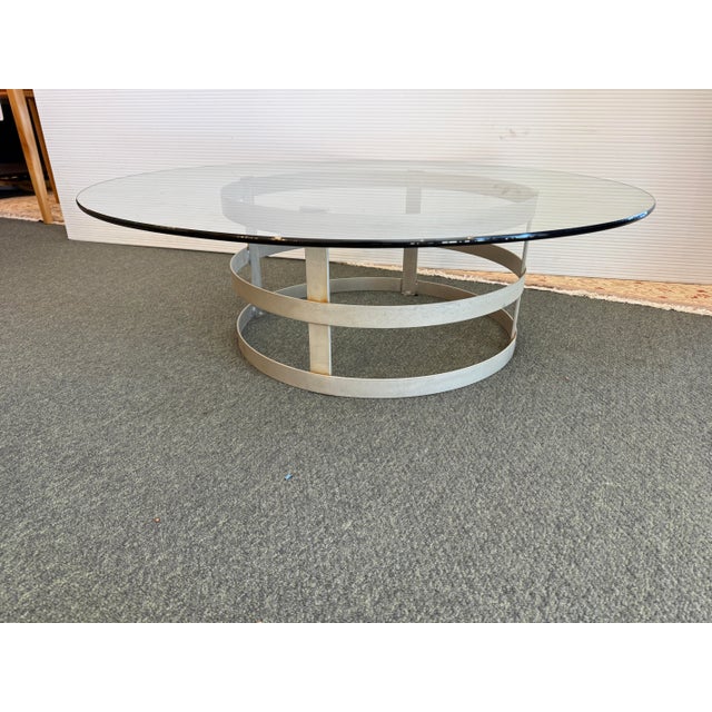 Design Plus Gallery presents a Steel Drum Coffee Table. The base anchors a wide tempered glass tabletop with beveled edge....