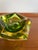 A striking vintage Mandruzzato Murano glass ashtray featuring a deep green center surrounded by amber and thick clear...