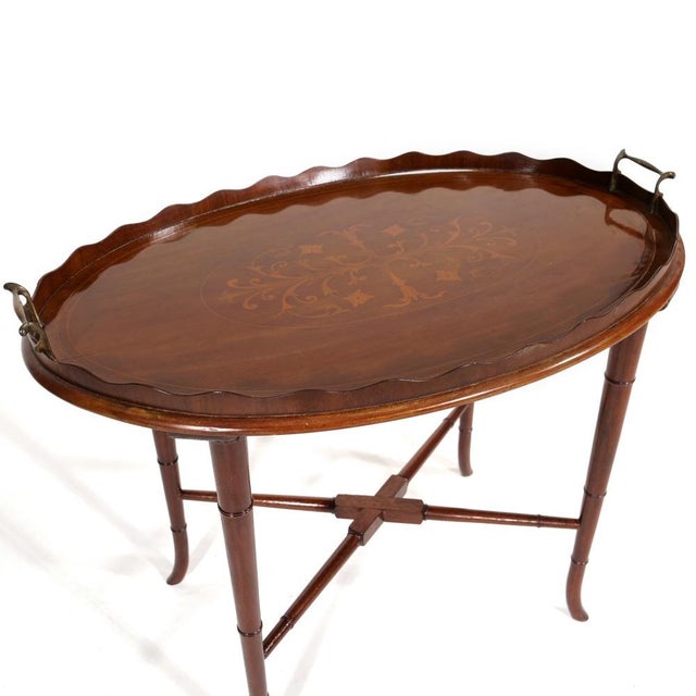 An antique Edwardian style mahogany tray-top ocoffee table with an oval gallery-edged removable tray with a scalloped pie-...