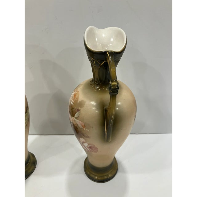 This pair of ceramic ewers was hand painted in Austria The romantic theme of roses are pure Victorian elegance