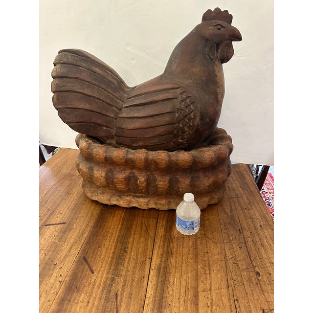 Eye catching monumental rare carved wood hen resting in a nest. Makes an incredible centerpiece or sculptural accessory...