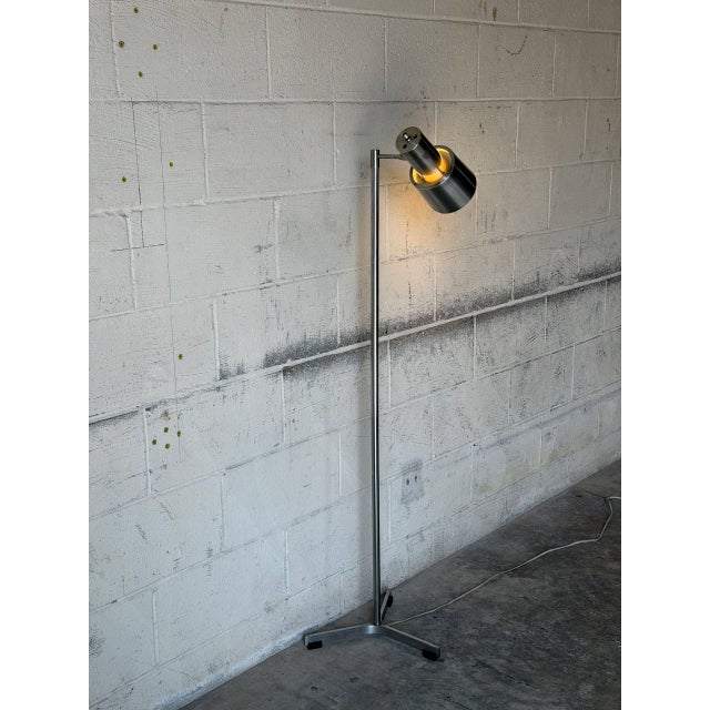 This adjustable metal floor lamp delivers sleek task lighting with a single directional spotlight shade. Built with a...