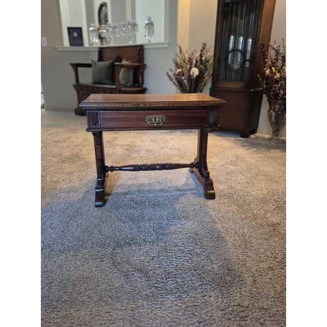This furniture piece is a 19th-century Victorian or Regency-style trestle side table, likely crafted from a rich hardwood...