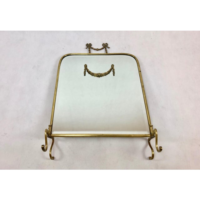 A very decorative mirror. The frame made in the baroque style, entirely of brass, with rich decoration. The pane is...