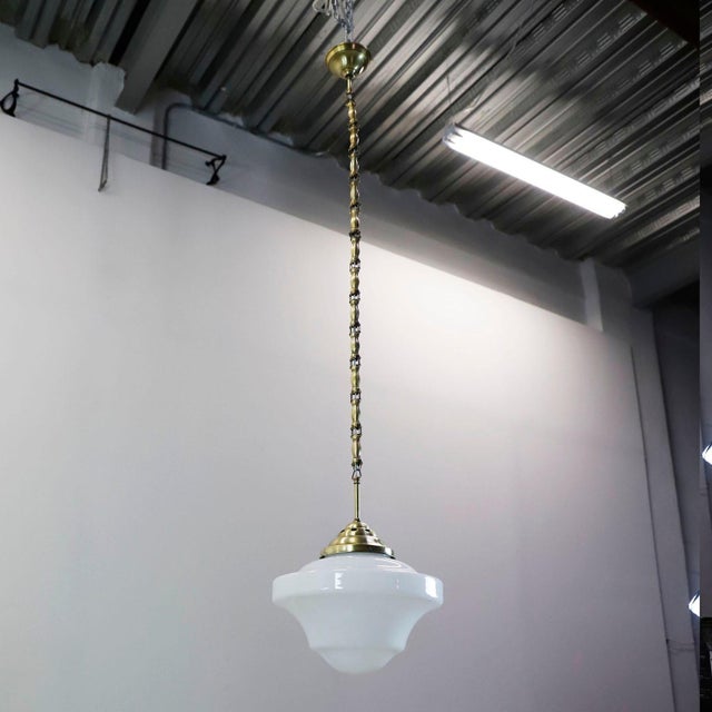 Circa 1930. We offer this Pair of Art Deco pendant lights made in milk glass Beautiful Long Chain Made of Brass. Excellent...