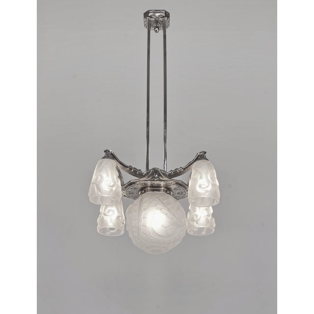 Degué A French 1930s art deco chandelier in nickel plated solid brass or bronze. The beautiful mounting of excellent...