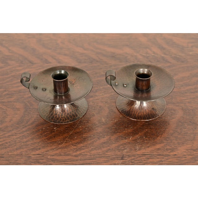 A gorgeous pair of Arts & Crafts period hand hammered copper chambersticks or candlesticks with handles By Roycroft...