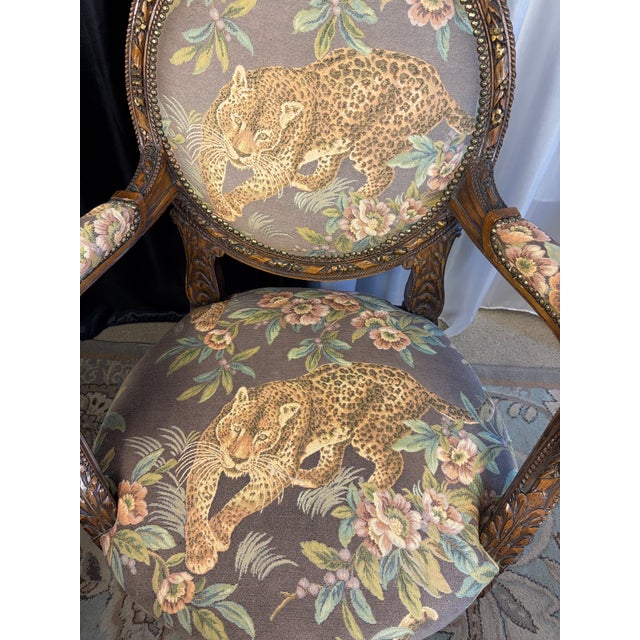 Striking French Transitional style armchair (fauteuil à la reine) featuring exceptional hand-carved details. The frame...