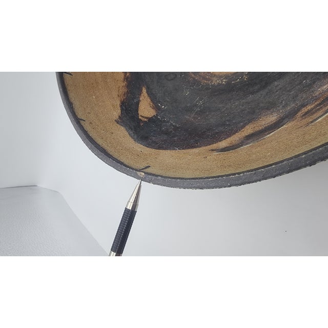 Large hand-thrown stoneware bowl with expressive iron-oxide brushwork interior, olive ash-glazed exterior, and signed foot
