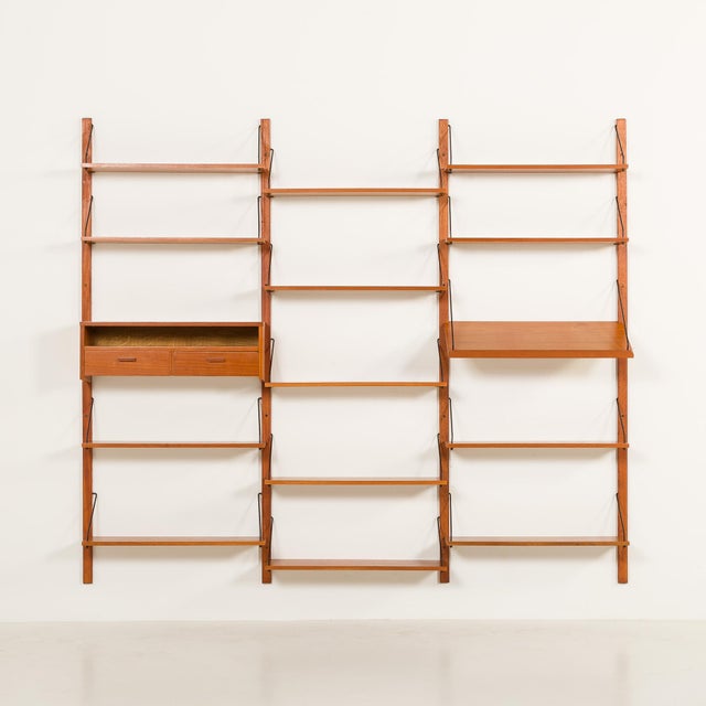 This elegant mid-century wall unit closely resembles poul cadovius or preben sorensen designs and was made in the same...