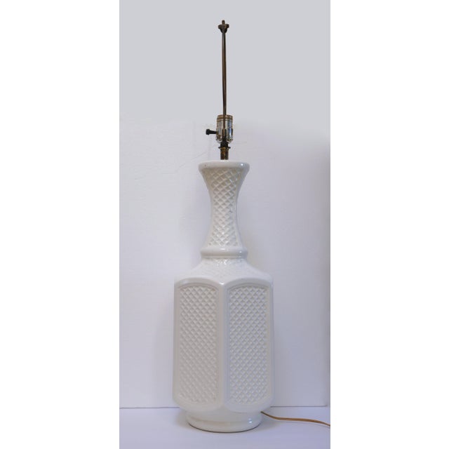 The raised relief of the cross-hatch pattern on this lamp gives it a modern and sleek feel, but this is a vintage ceramic...